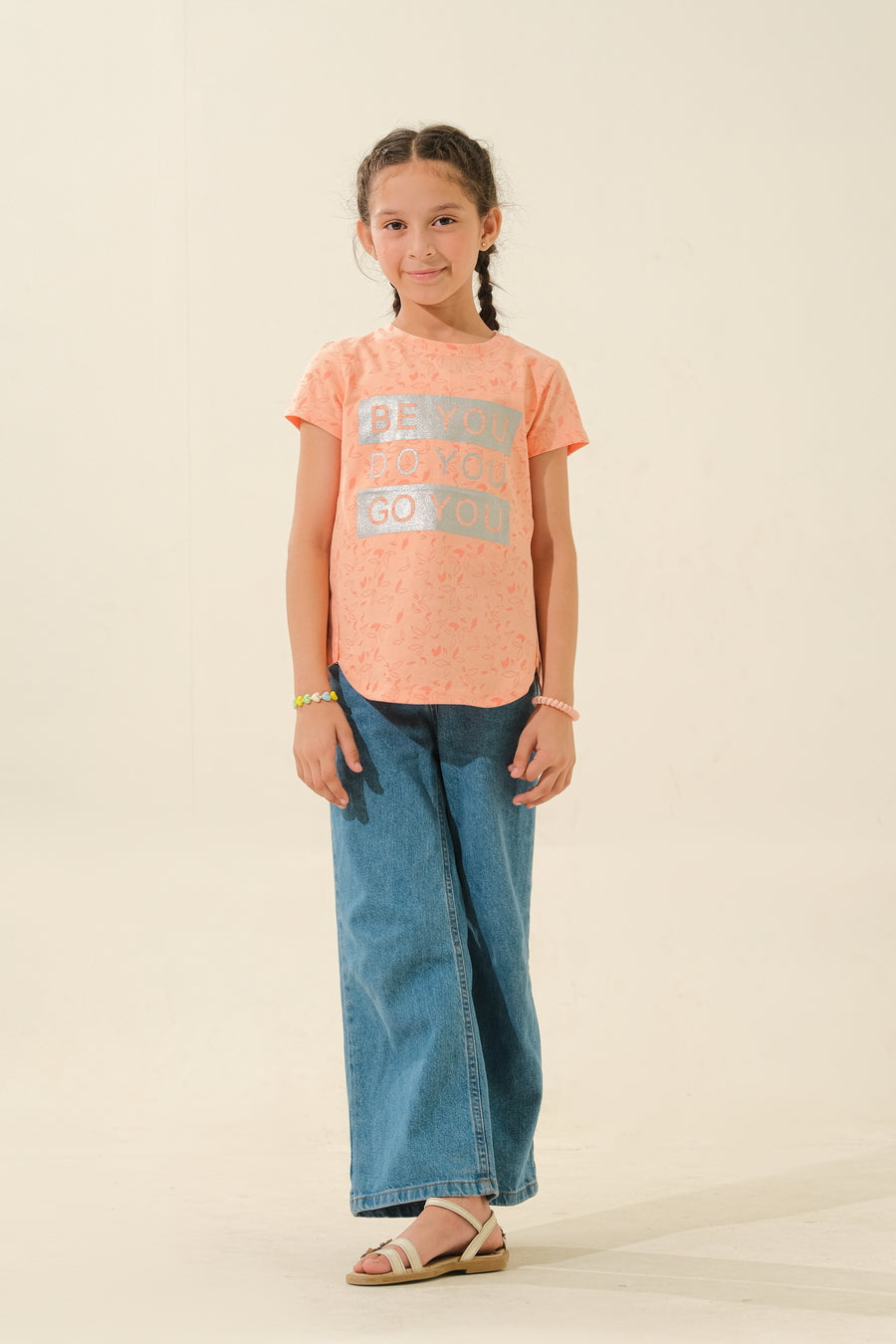 Girl in Peach Graphic Shirt