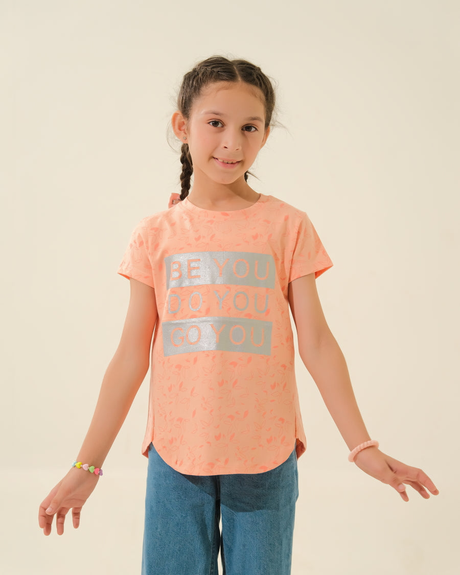 Girl in Peach Graphic Shirt